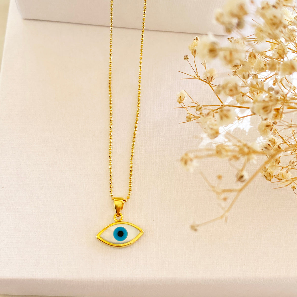 Gold necklace deals with blue eye