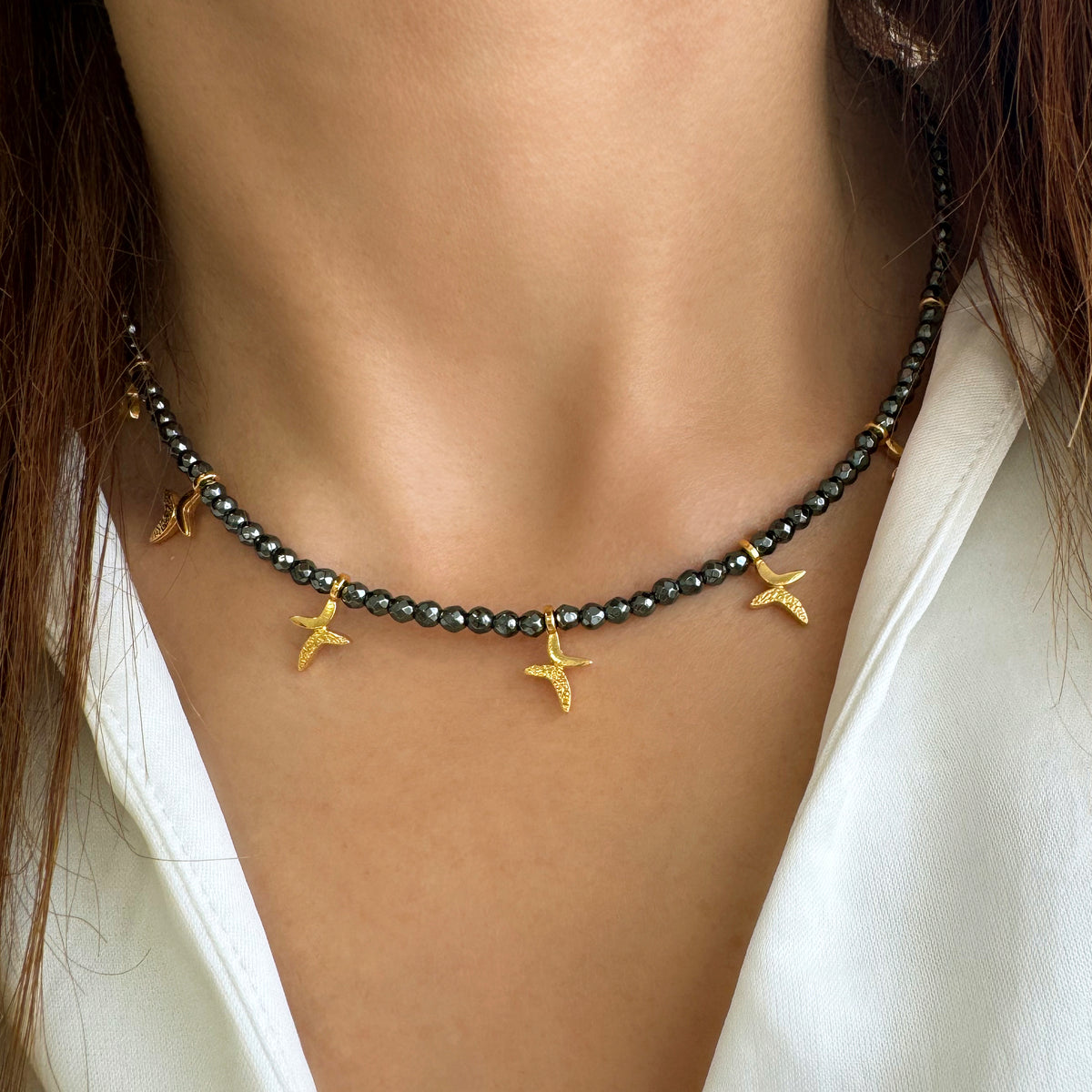 Multi-charm necklace with gold cross charms and hematite Gemstone beads