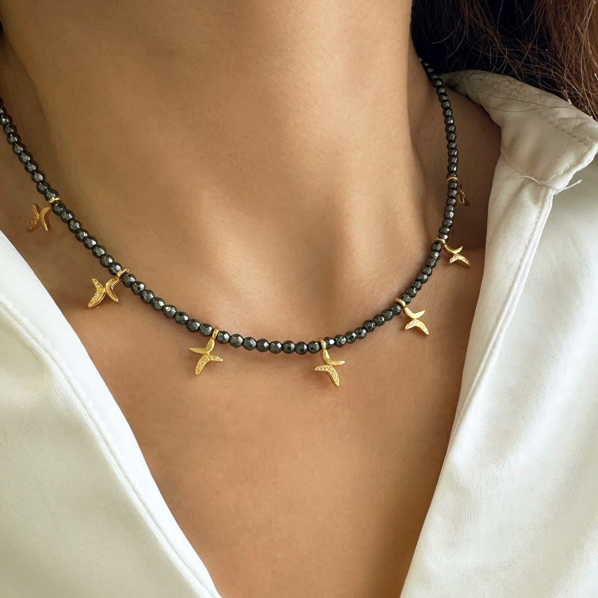 Multi-charm necklace with gold cross charms and hematite Gemstone beads