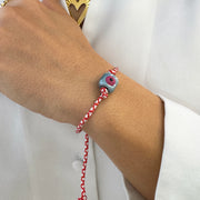 March bracelet with an evil eye cube