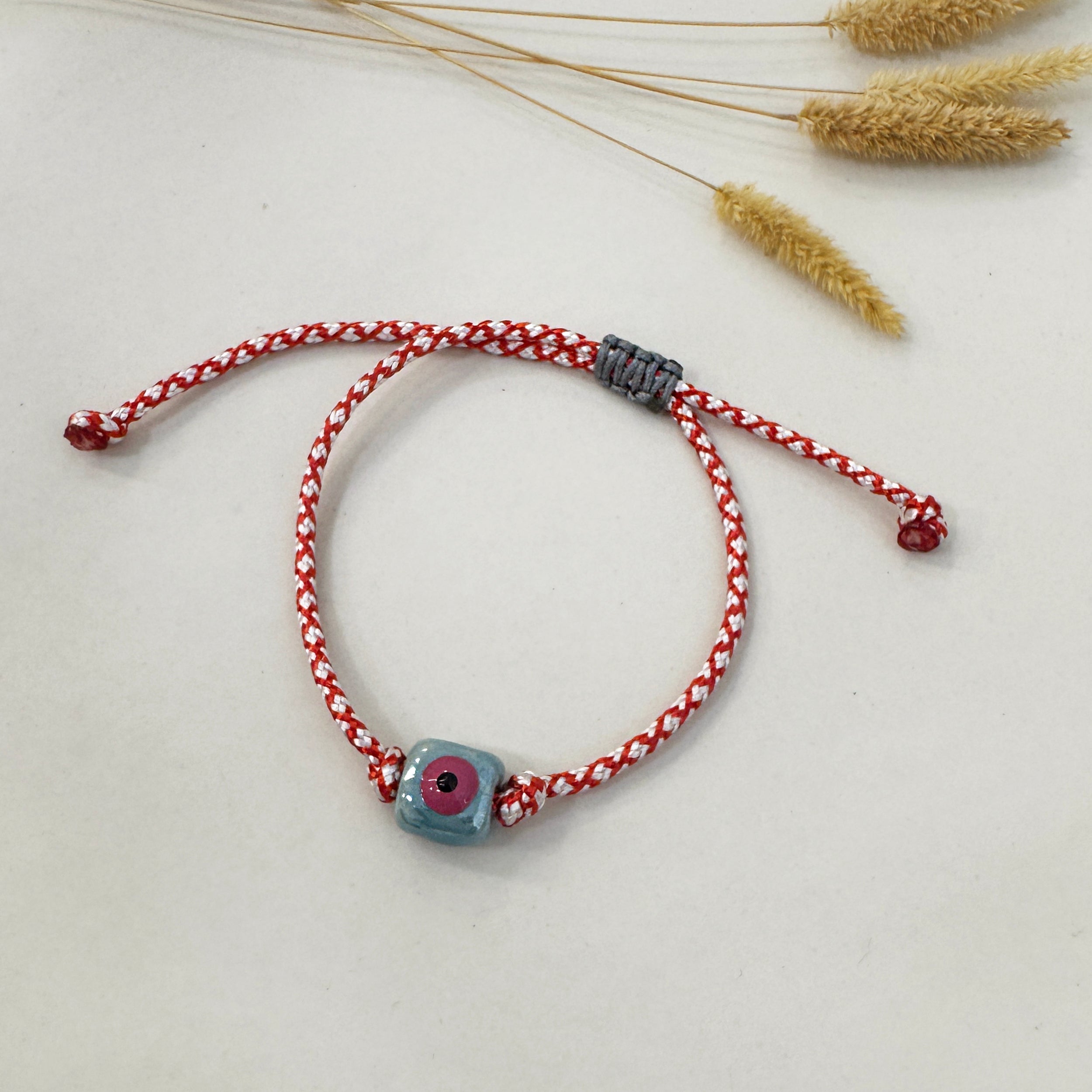 March bracelet with an evil eye cube