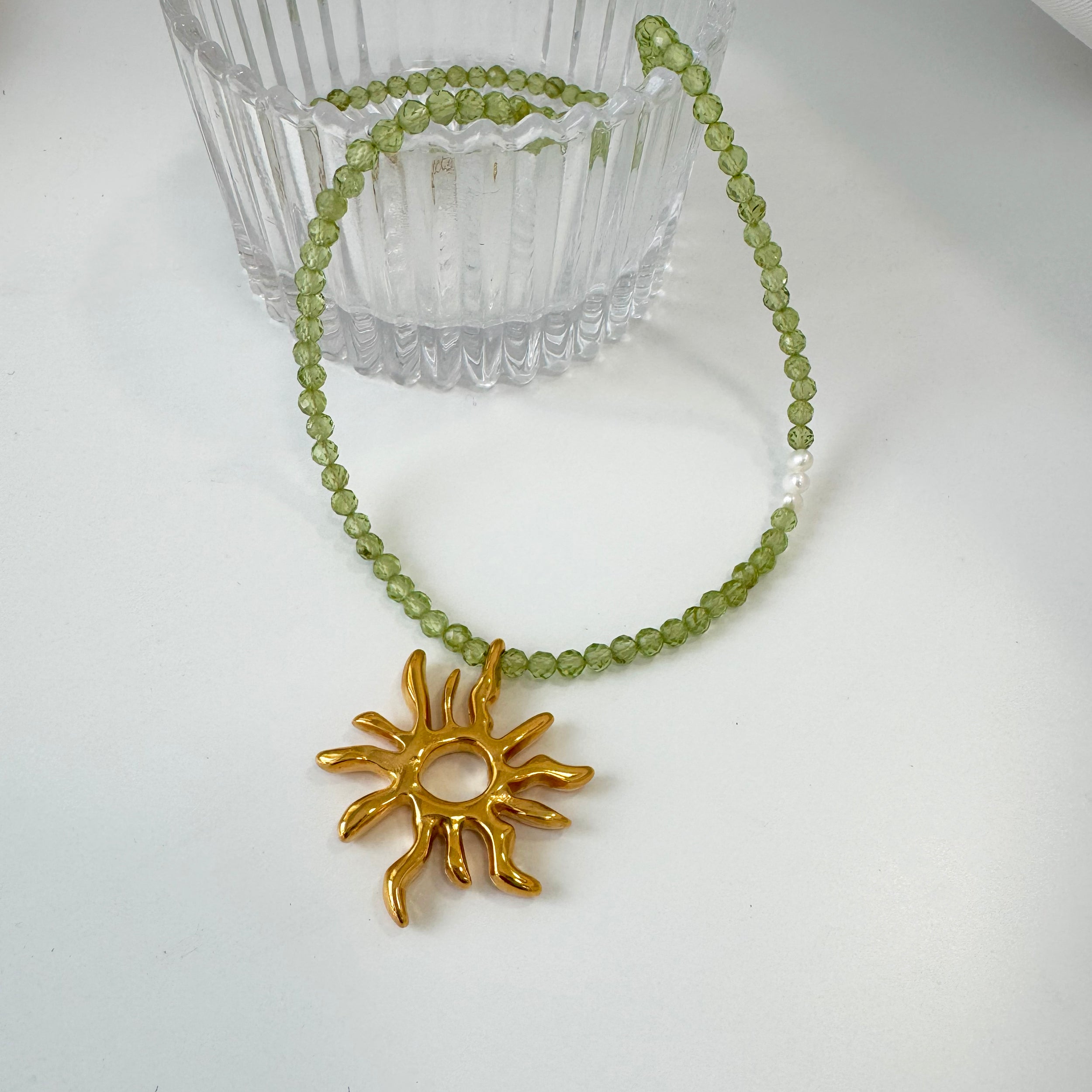 Gold sun charm choker necklace with peridot gemstone