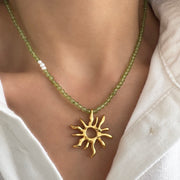 Gold sun charm choker necklace with peridot gemstone