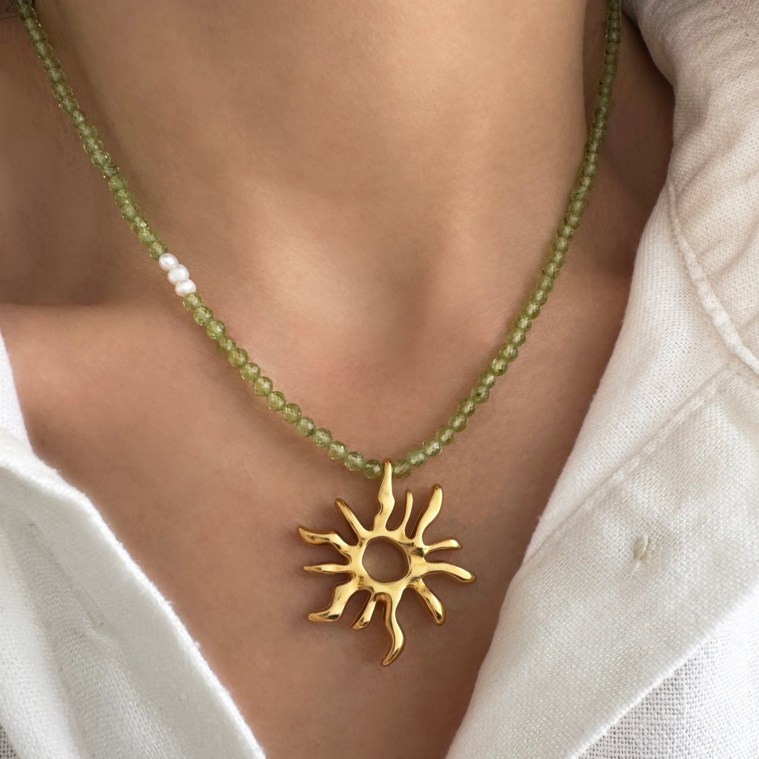 Gold sun charm choker necklace with peridot gemstone