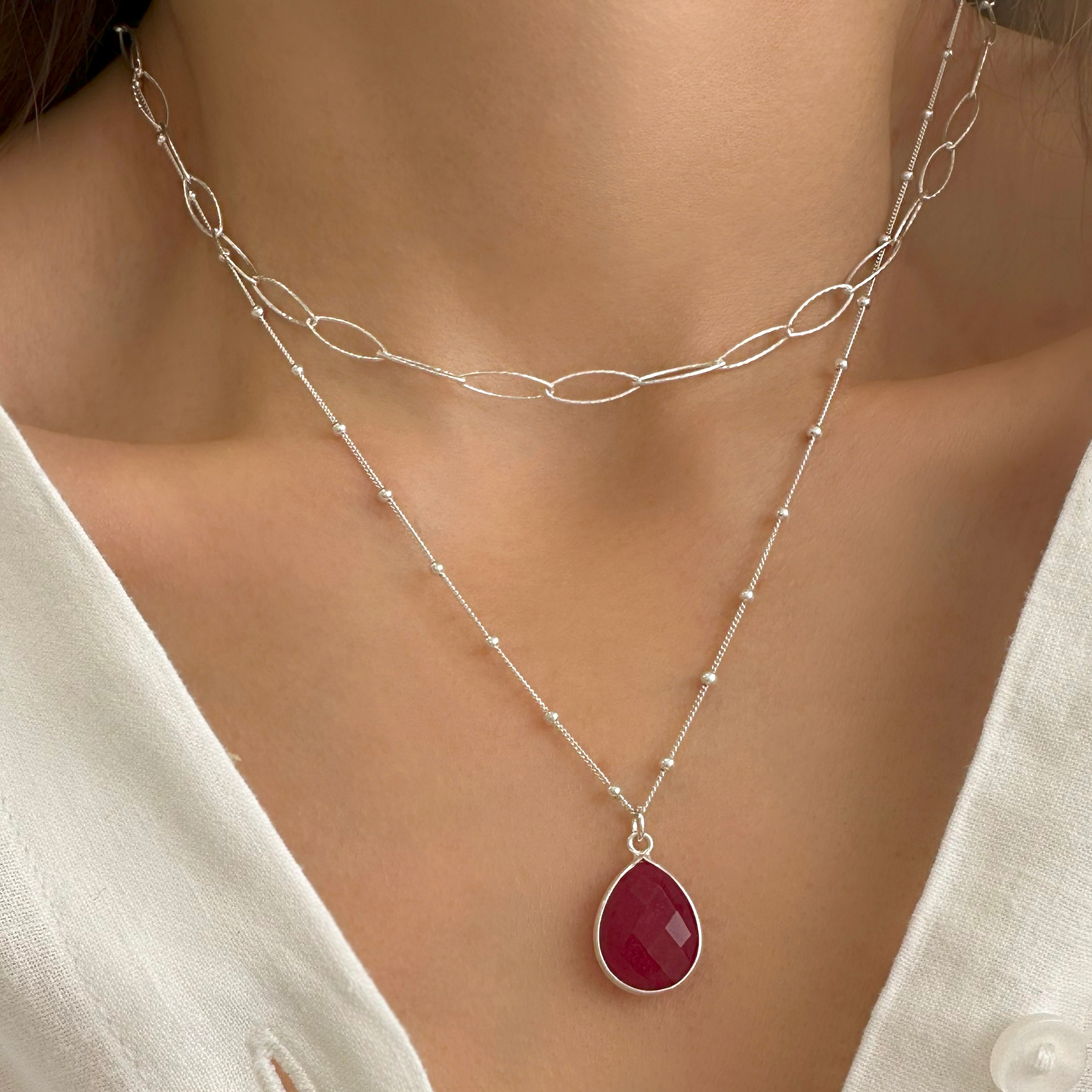 Layered necklace with a ruby pendant and paperclip chain