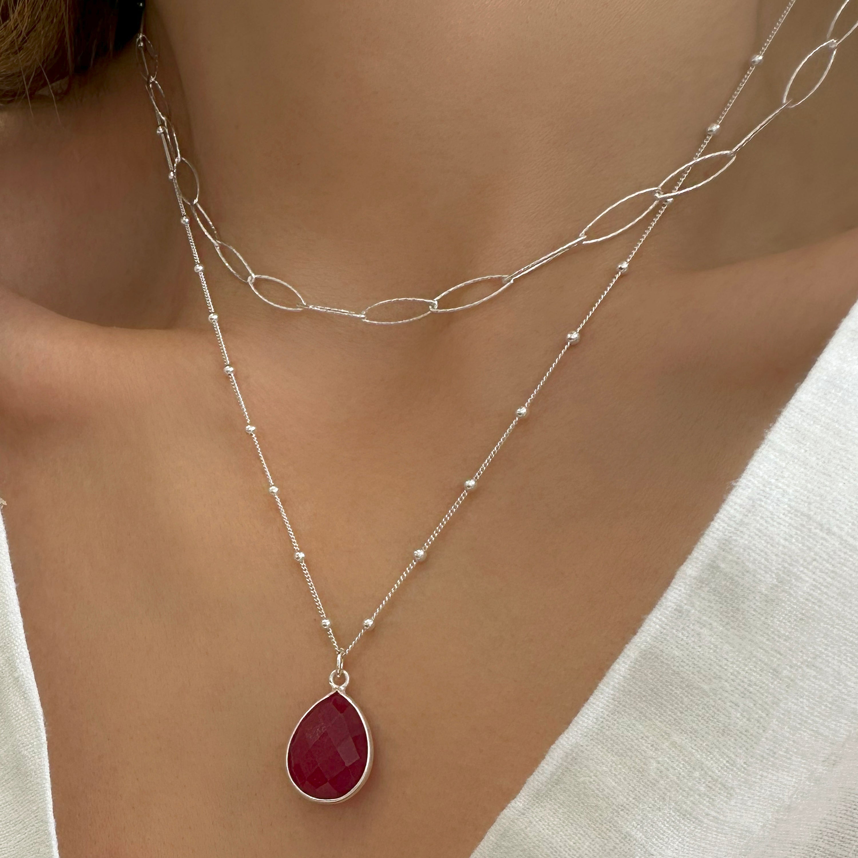 Layered necklace with a ruby pendant and paperclip chain