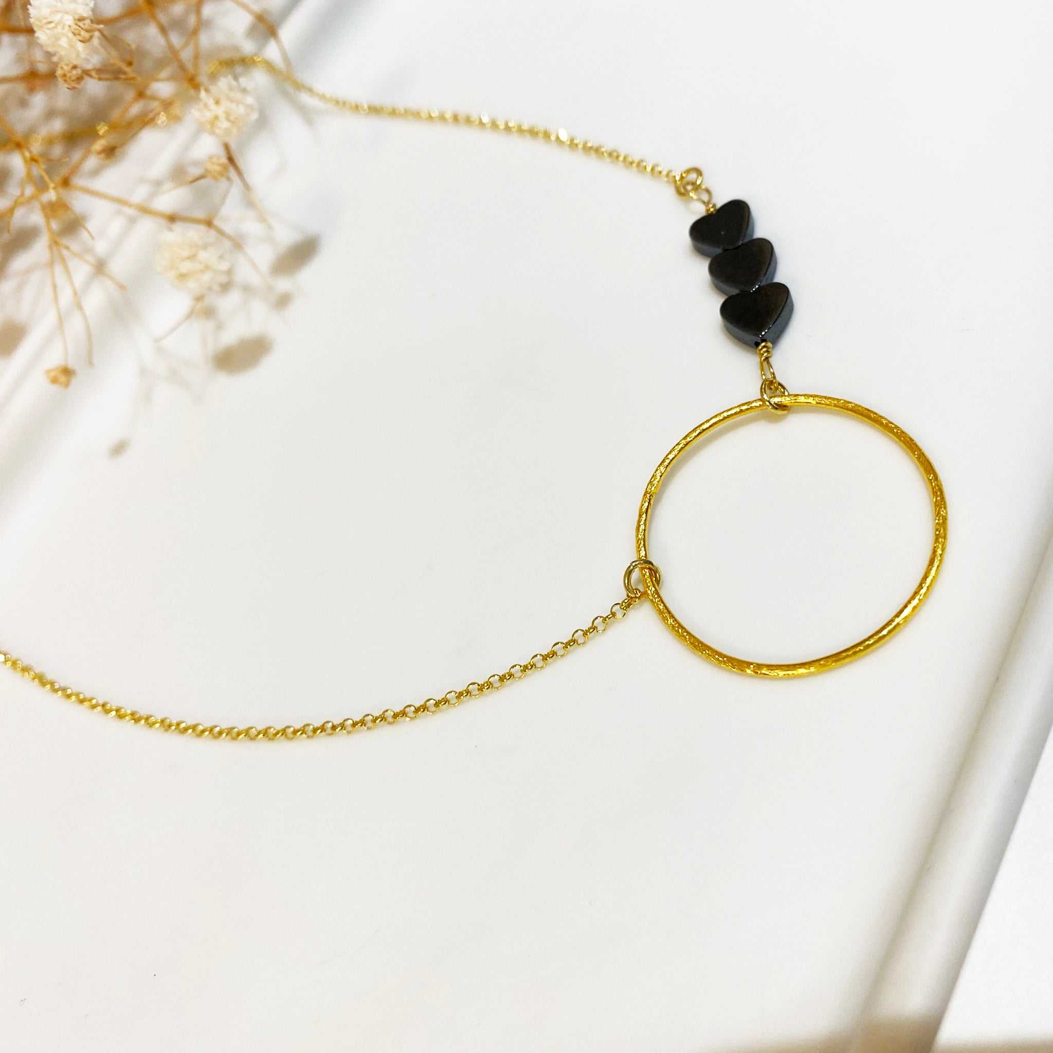 Dainty necklace with a gold circle pendant & 3  Tiny hematite hearts