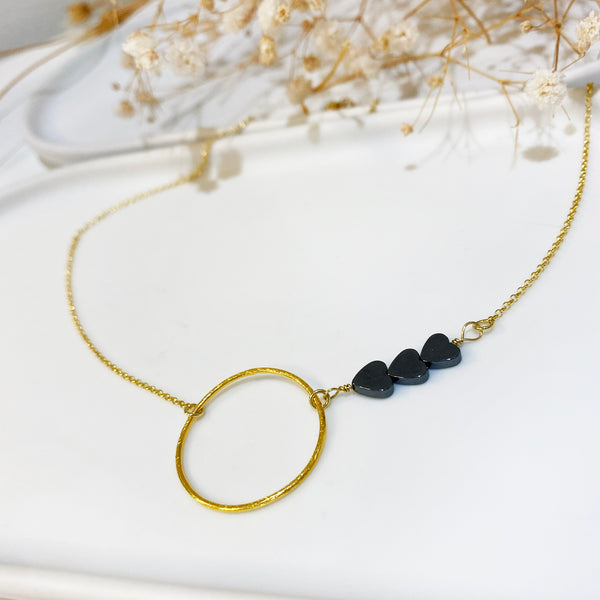 Dainty necklace with a gold circle pendant & 3  Tiny hematite hearts