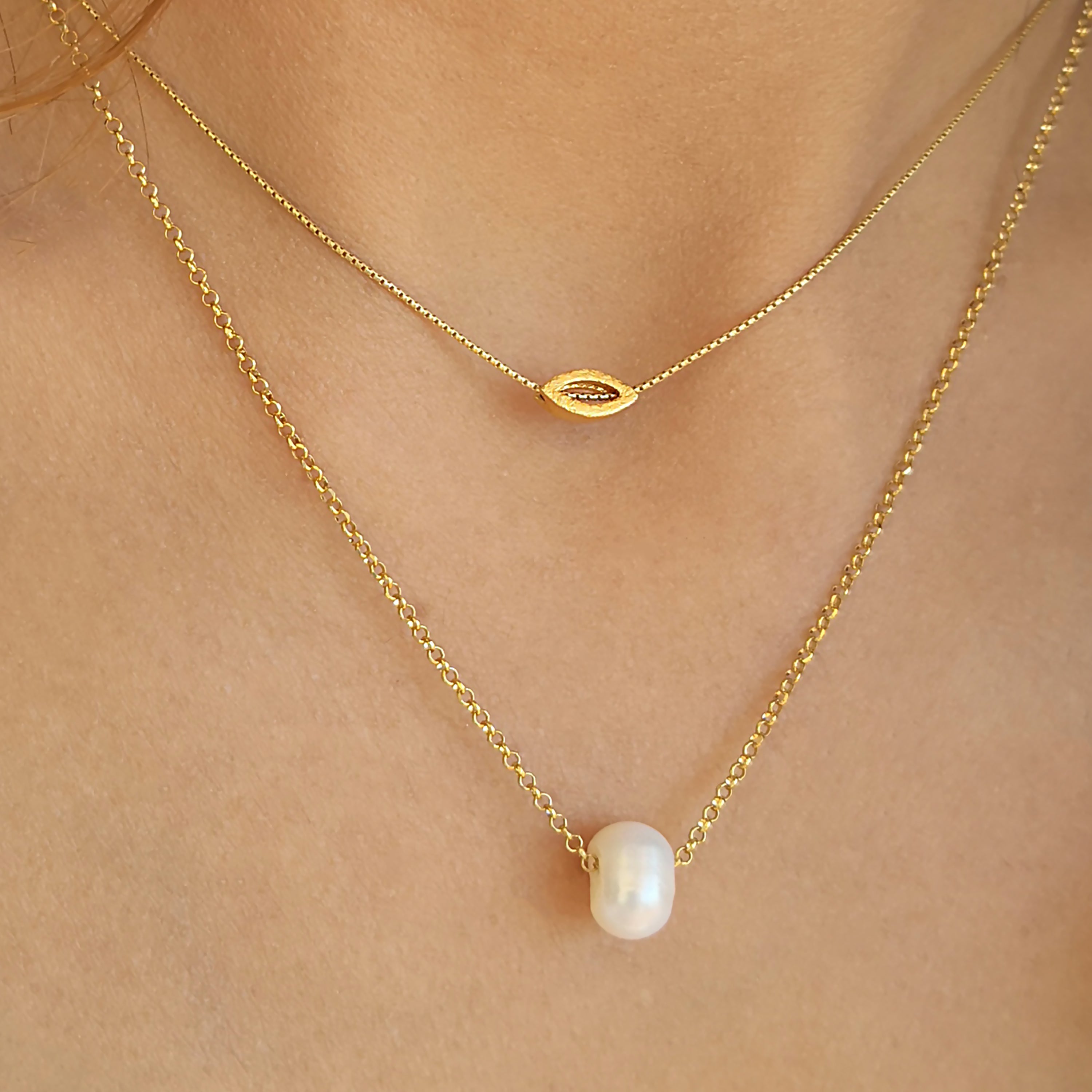 Layered Necklaces set with a tiny eye pendant and a genuine pearl.