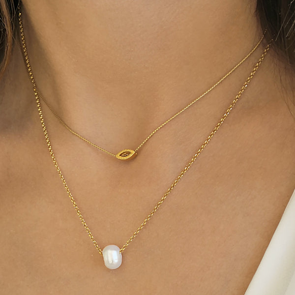 Layered Necklaces set with a tiny eye pendant and a genuine pearl.